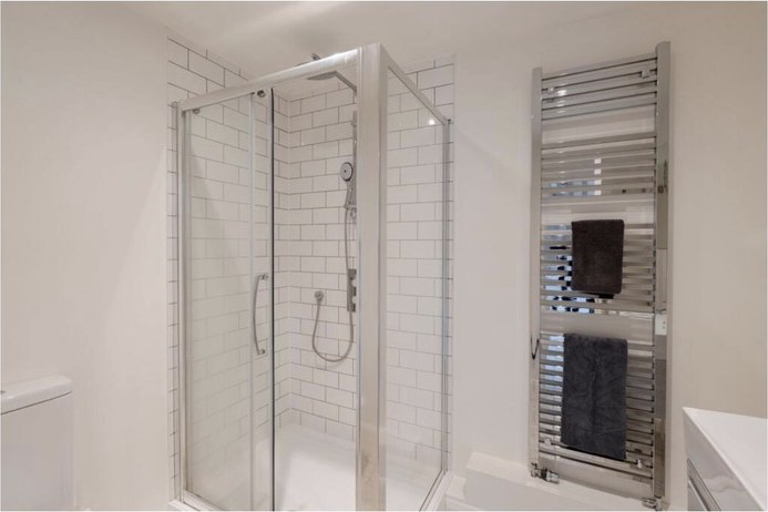 Shower room with a tiled enclosure and heated towel rail