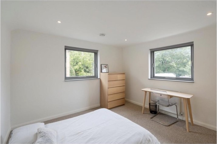 A double bedroom with two windows